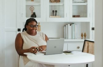 Person working at a laptop in a compact home workspace