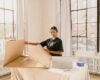 Small business owner packing customer orders at a work table