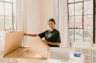 Small business owner packing customer orders at a work table