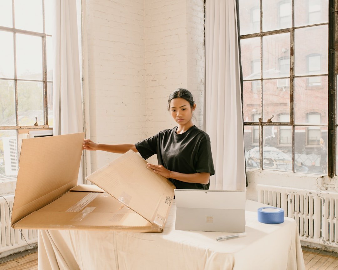 Small business owner packing customer orders at a work table