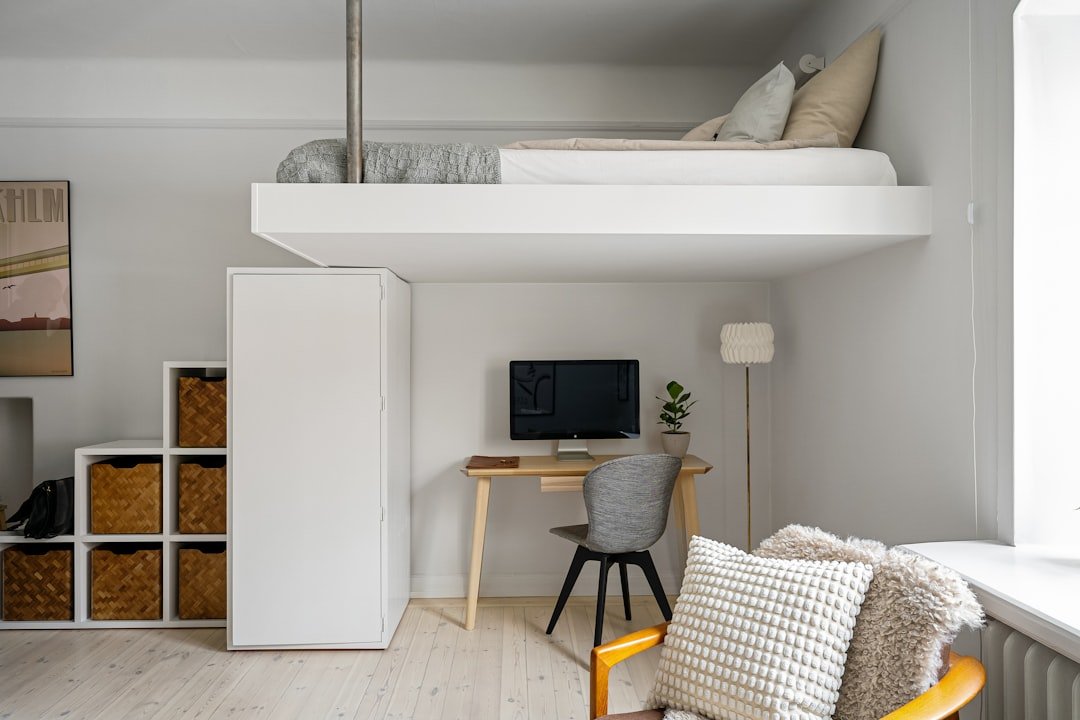 Compact residential room with a loft bed and desk